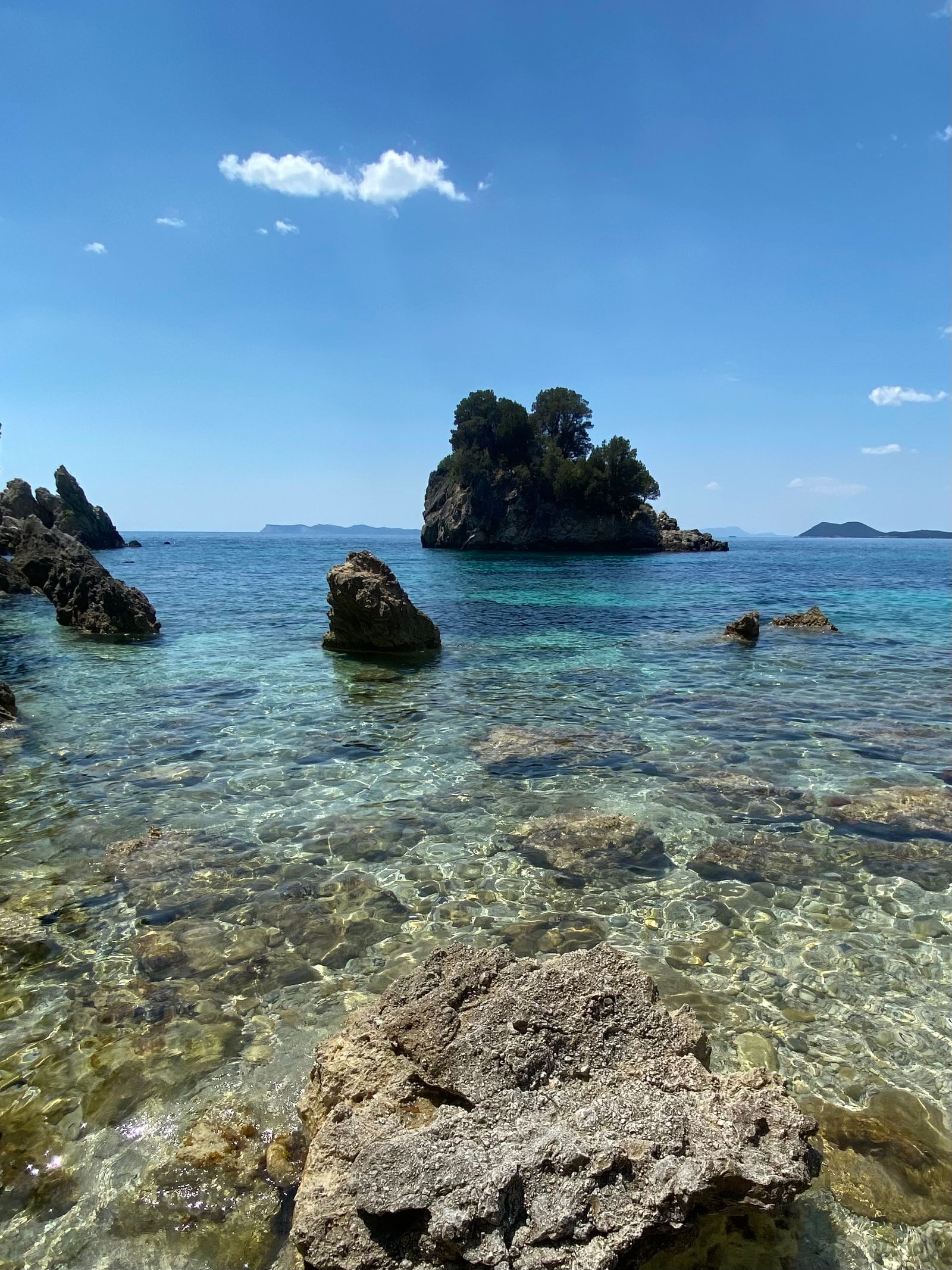 Clear shallow water and rocky islets at a quiet Ionian island cove