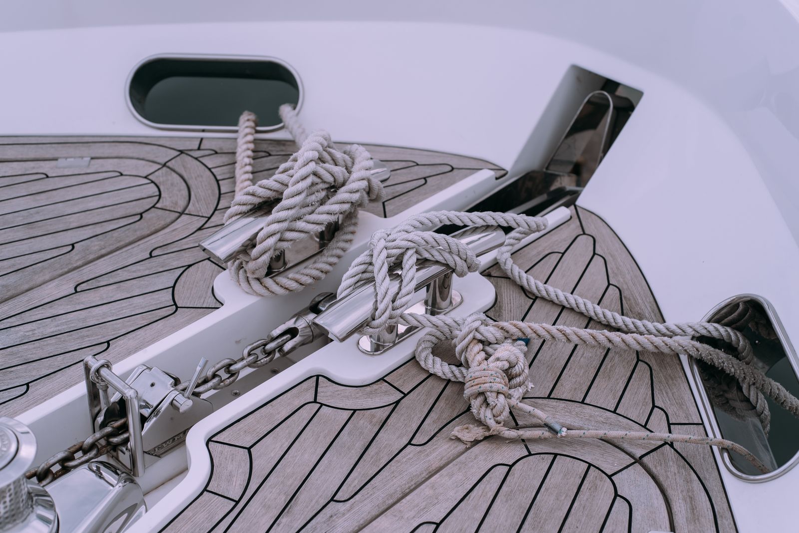Knotted ropes and anchor chain on a yacht deck